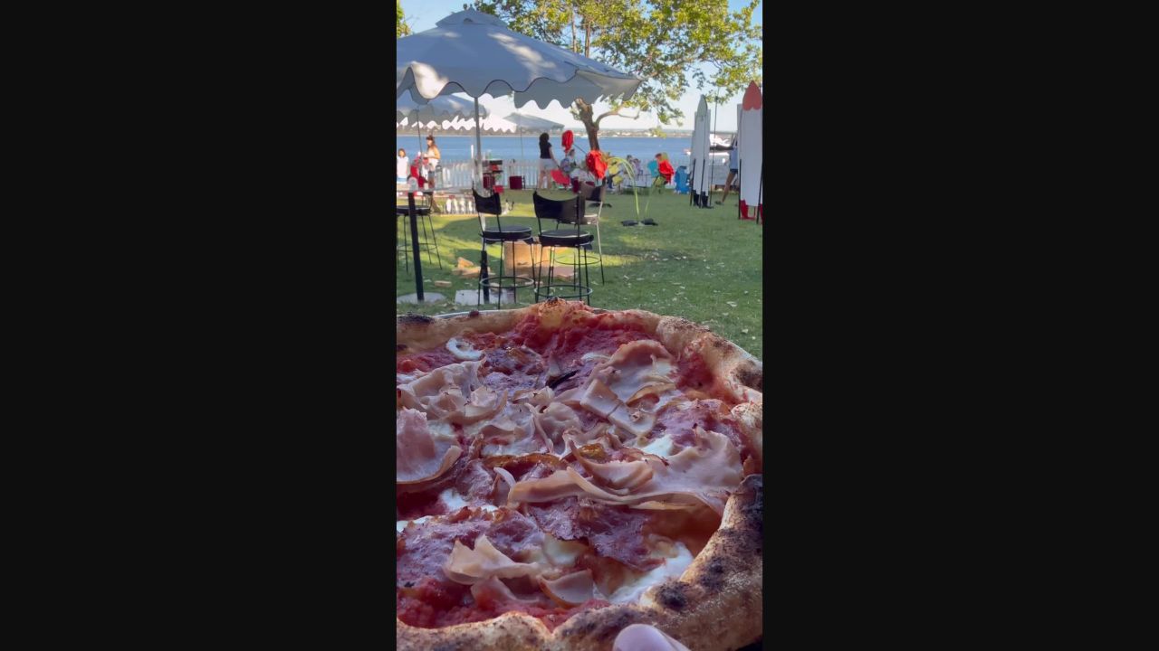 Wood-fired Impasto pizza at an outdoor riverside event
